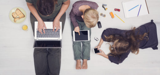 Family screen time, with Mom on laptop, son on tablet, and daughter on phone